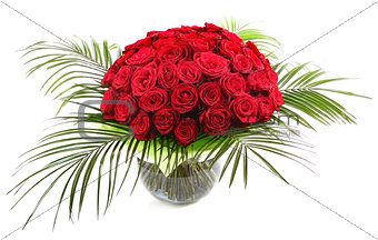A large bouquet of red roses in a transparent glass vase. The is