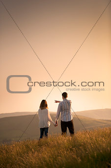 couple pointing to a beautiful landscape