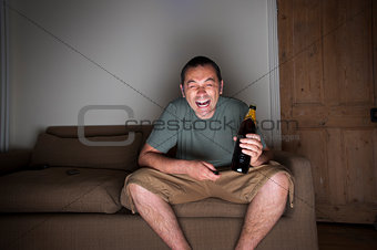 man watching tv laughing