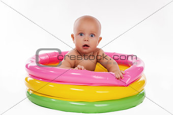 Baby swimming in kid inflatable pool