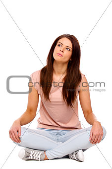 Brunette woman sat looking up thinking