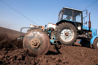 Tractor with sower on the field