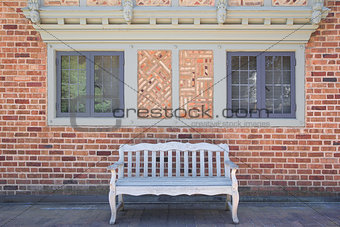 House Brick Exterior with Wood Bench