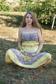 Beautiful pregnant woman relaxing in the park