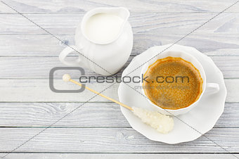 coffee and milk jug on a wooden table