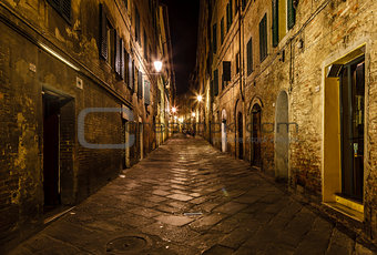 Narrow Alley With Old Buildings In Medieval Town of Siena, Tusca