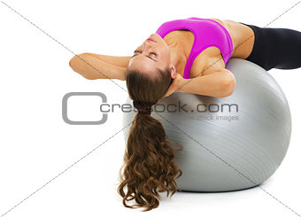 Fitness young woman making exercise on fitness ball