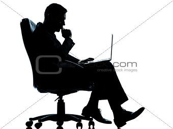 one business man computer computing serious sitting in armchair 
