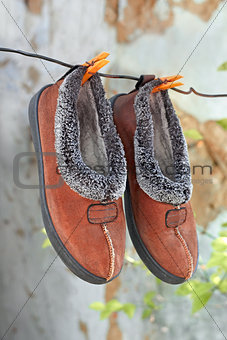 Slippers hanging on a wire