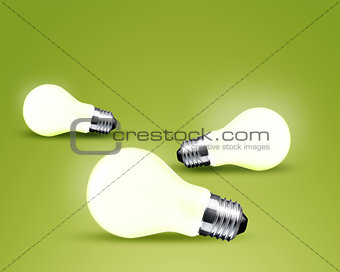 Three glowing Light bulb idea on green background