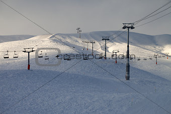 Ski slope with chair-lift in evening