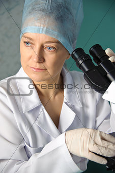 Portrait of a female doctor with a microscope.