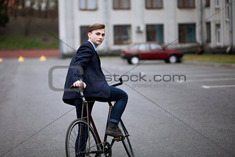 Young handsome man on a cycle