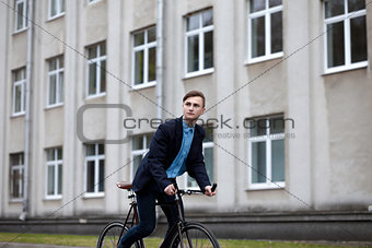 Young handsome man on a cycle