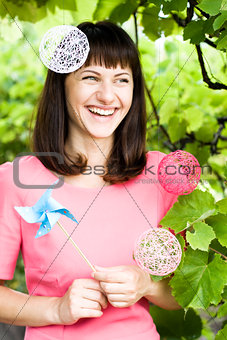 Beautiful girl laughing and holding a windmill