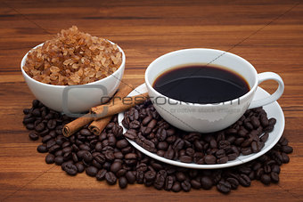 Coffee cup and beans on wood table