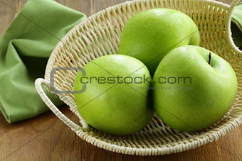 green apples "Granny Smith" in a basket on the table