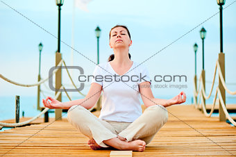 woman dressed in white doing yoga