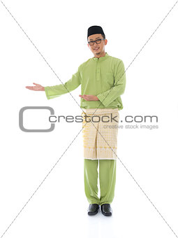 Traditonal Malay man with welcome gesture during ramadan isolate