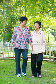 Asian senior women walking at outdoor park.
