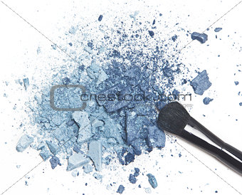 Crushed blue eyeshadow with makeup brush