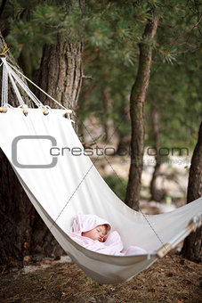 baby sleeping in hammock