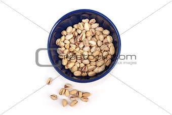 Roasted and salted pistachios in blue bowl