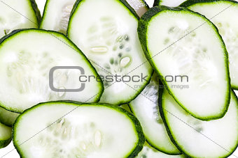 Slices of green cucumbers background