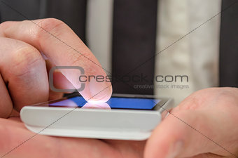 Finger of a businessman pointing at touch screen