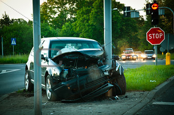 wrecked car after hitting a lamp post