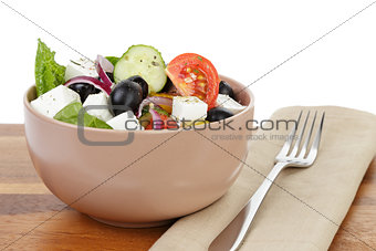 fresh greek salad in clay bowl