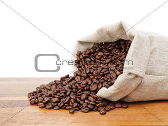 roasted coffee beans spill out of the bag