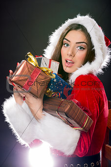 Santa girl with Christmas gifts.