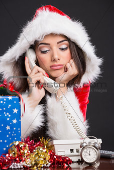 Unhappy Santa girl on the phone