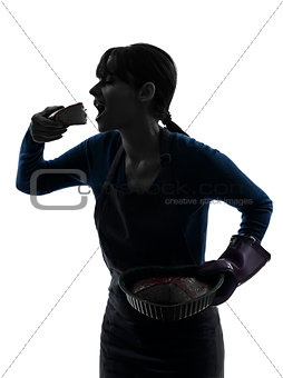 woman greedy cooking eating chocolate cake silhouette