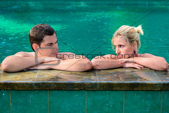 Sad and unhappy couple in swimming pool