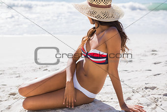 Young sexy woman wearing straw hat relaxing