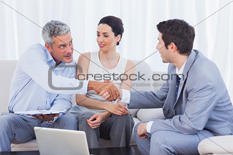 Salesman closing a deal with a smiling couple