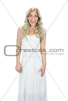 Surprised attractive model in white dress posing