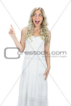 Astonished attractive model in white dress posing