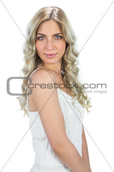 Relaxed attractive model in white dress posing