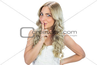 Seductive model in white dress posing hiding secret