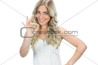 Positive seductive model in white dress waving
