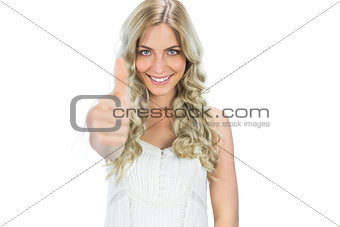 Cheerful seductive model in white dress thumb up