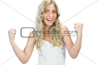 Happy seductive model in white dress cheering