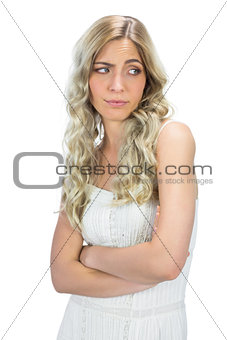 Uninterested model in white dress rising her eyebrow