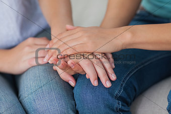 Close friends touching hands