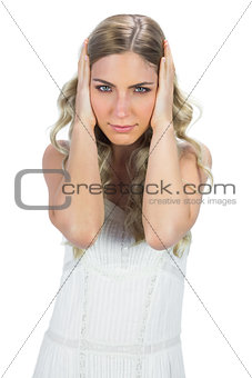 Mysterious sensual blonde holding her head