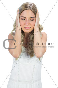 Pensive sensual blonde holding her head