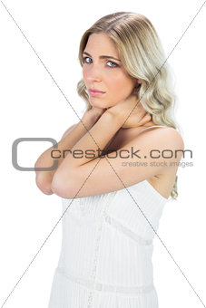 Sensual blonde holding her painful neck